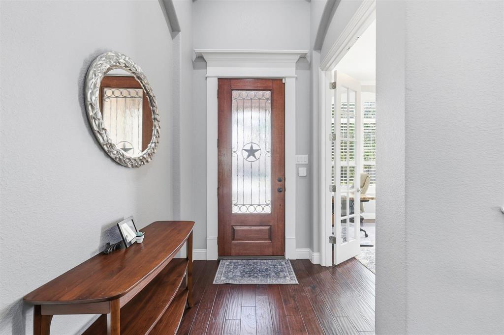 117 Birdcall Lane Argyle, TX 76226 - Photo 3 of 40 Foyer entrance featuring dark wood-style floors and a textured wall