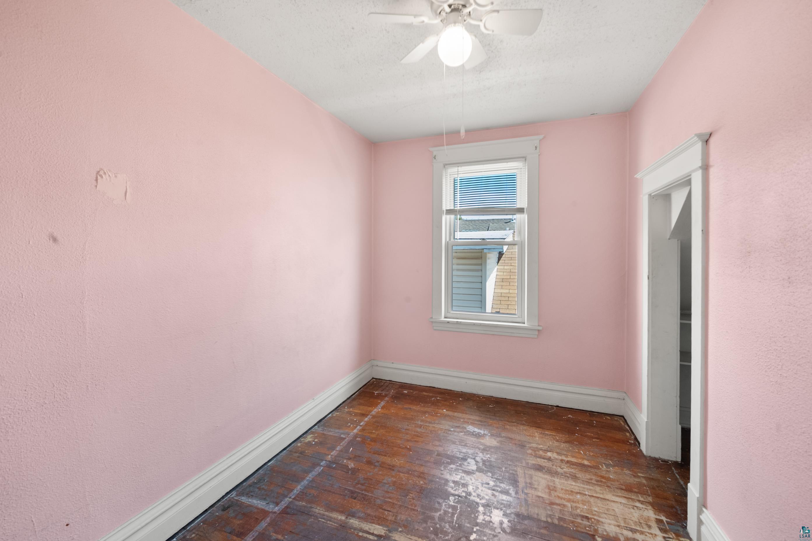 3067 Restormel Street Duluth, MN 55806 - Photo 12 of 25 Room featuring an overhead ceiling fan with lighting, a single window with white trim, and a doorway with white trim