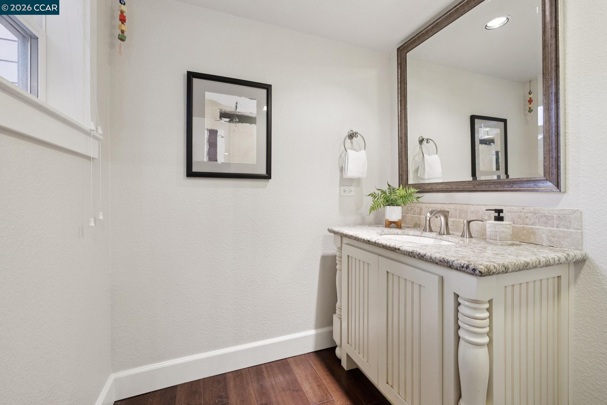1980 Meadow Road Walnut Creek, CA 94595 - Photo 39 of 59 a bathroom with a granite countertop sink and a mirror