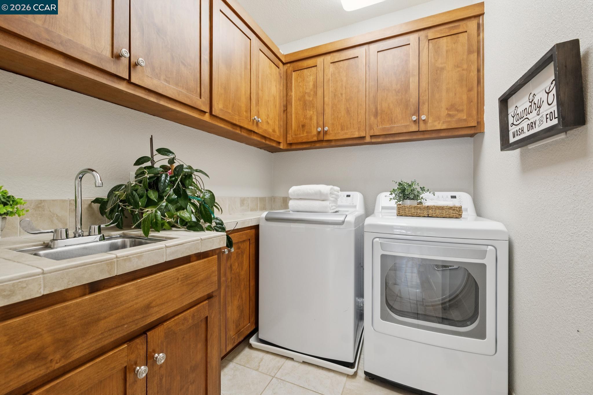 1980 Meadow Road Walnut Creek, CA 94595 - Photo 43 of 59 a utility room with sink dryer and washer