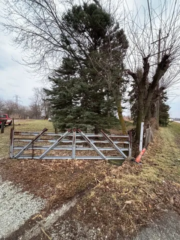 a view of a yard with wooden fence