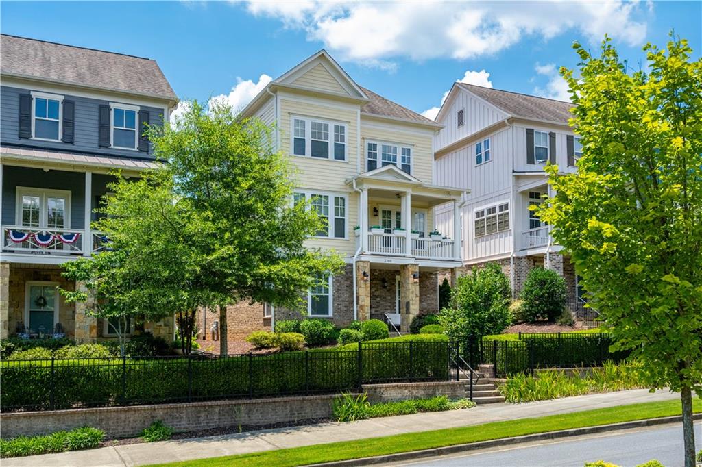 a front view of a residential houses with yard and green space