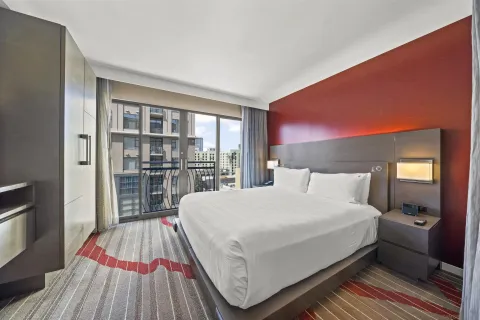 a bedroom with a bed and a view of kitchen