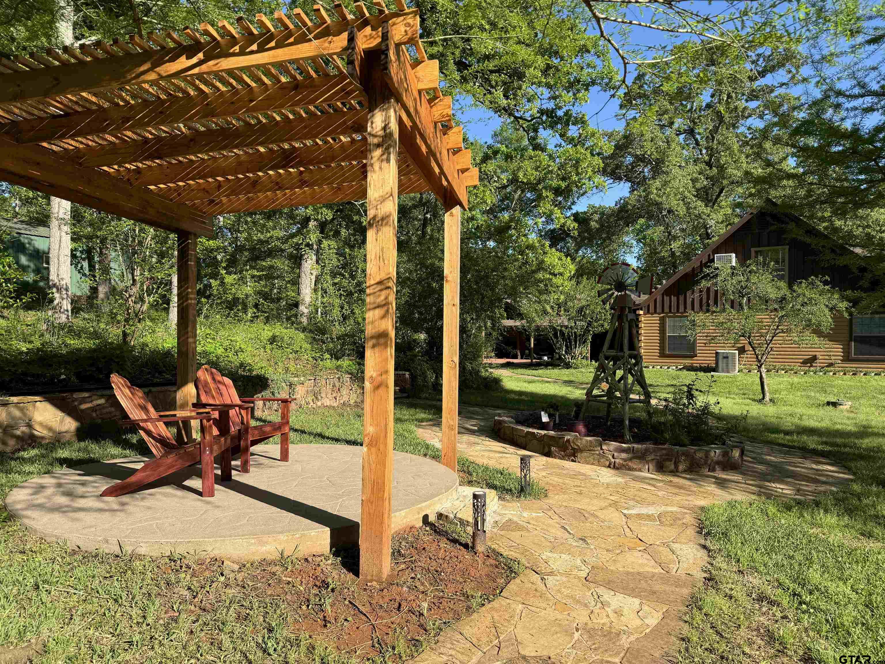 782 Rosie Wady Road Gladewater, TX 75647 - Photo 41 of 48 a view of a patio with a table chairs and a backyard