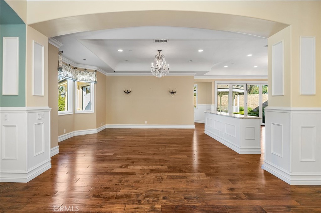 1450 North Nicky Way Orange, CA 92869 - Photo 15 of 64 a view of an empty room and kitchen with wooden floor