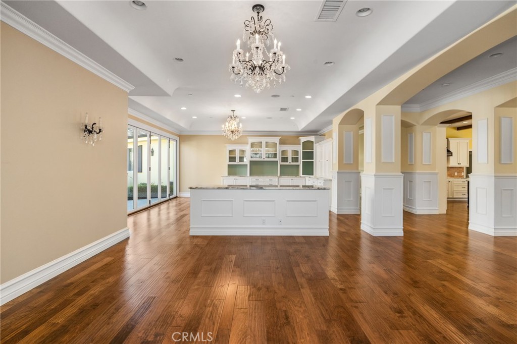 1450 North Nicky Way Orange, CA 92869 - Photo 16 of 64 a large hall with wooden floor and a large kitchen
