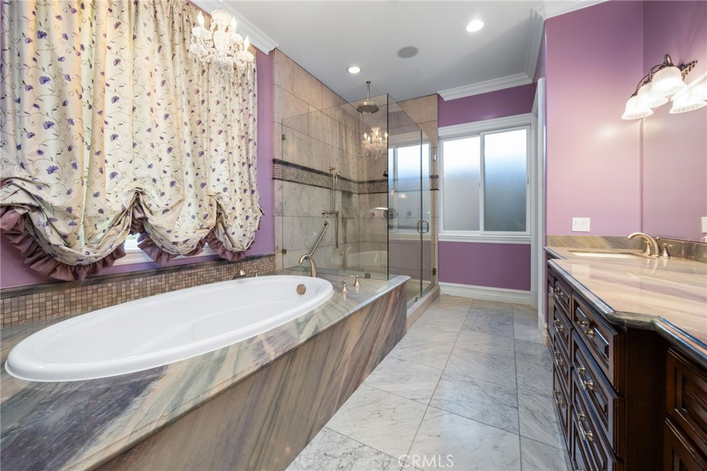 1450 North Nicky Way Orange, CA 92869 - Photo 30 of 64 a bathroom with a granite countertop sink a mirror a bathtub and shower