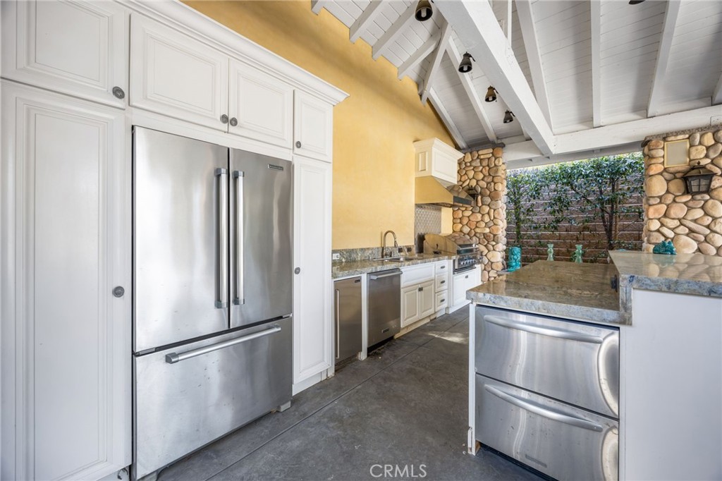 1450 North Nicky Way Orange, CA 92869 - Photo 59 of 64 a kitchen with stainless steel appliances granite countertop a refrigerator a stove and a sink with wooden floor