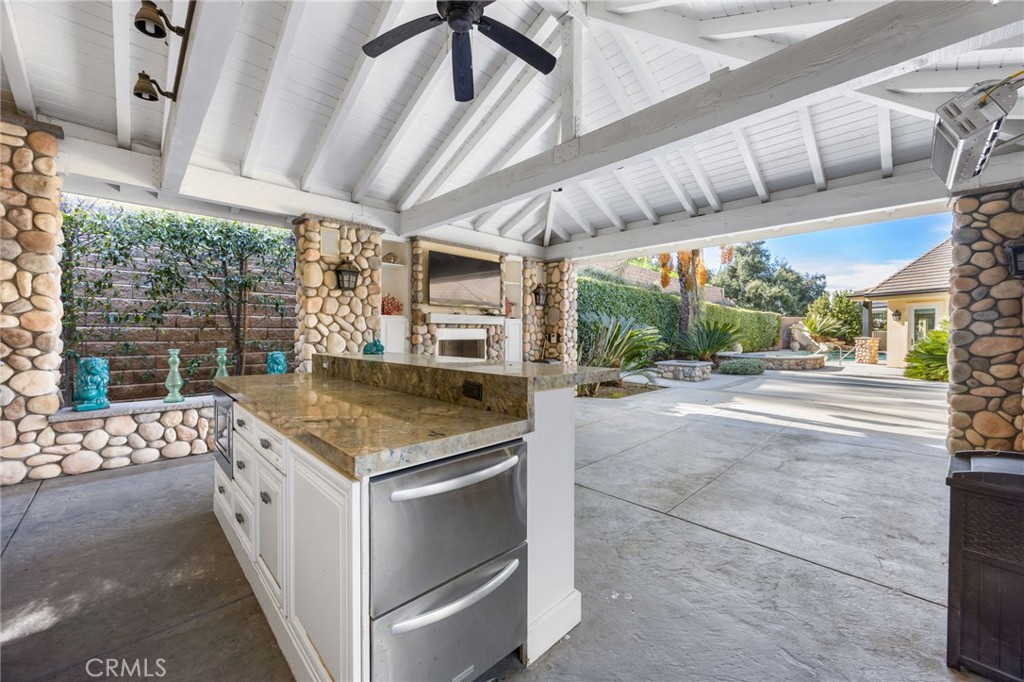1450 North Nicky Way Orange, CA 92869 - Photo 60 of 64 a open kitchen with stainless steel appliances kitchen island granite countertop a table and chairs in it