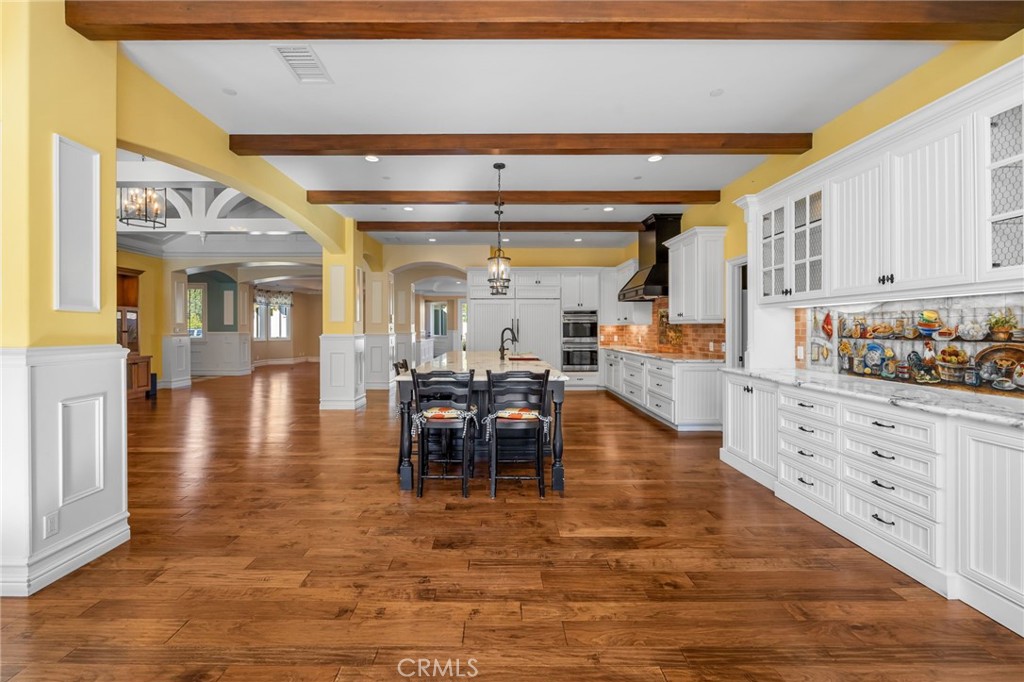 1450 North Nicky Way Orange, CA 92869 - Photo 8 of 64 a dining hall with stainless steel appliances granite countertop a stove and cabinets