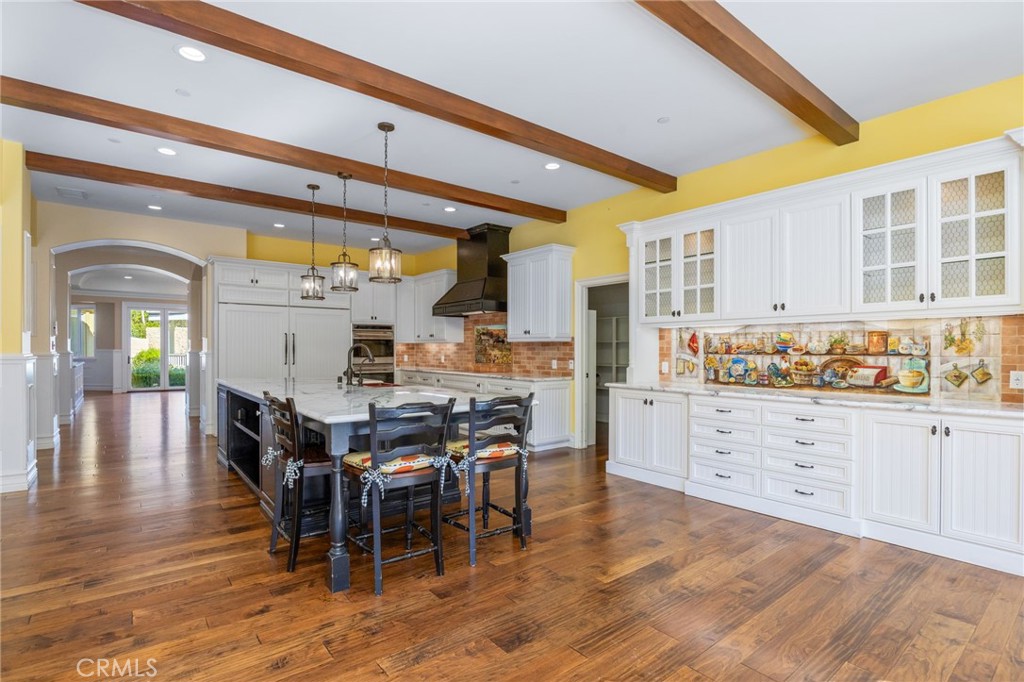 1450 North Nicky Way Orange, CA 92869 - Photo 9 of 64 a kitchen with stainless steel appliances kitchen island granite countertop a table and chairs in it