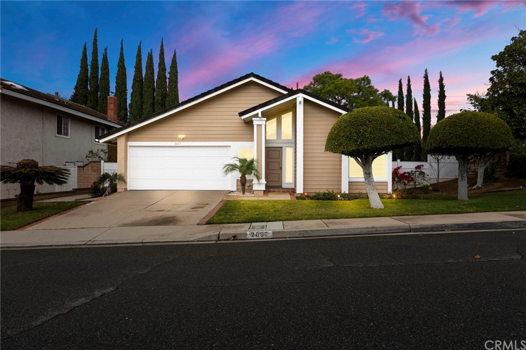 2697 Woodacre Street Brea, CA 92821 - Photo 1 of 1 a front view of a house with a garden and trees