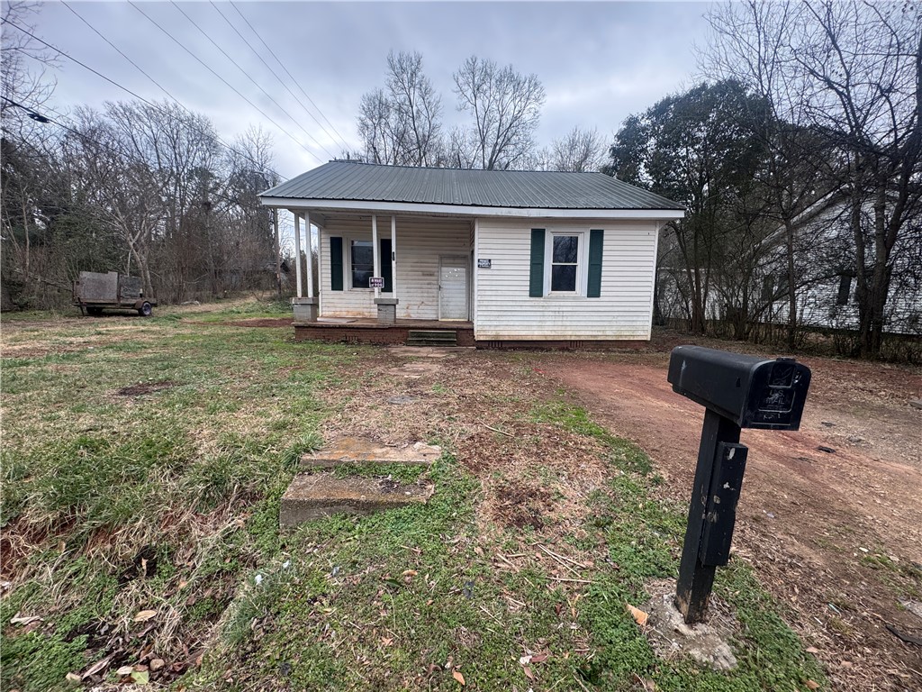 32 Ames Street Seneca, SC 29678 - Photo 12 of 14 This charming home offers a cozy retreat with a welcoming front porch and ample outdoor space.