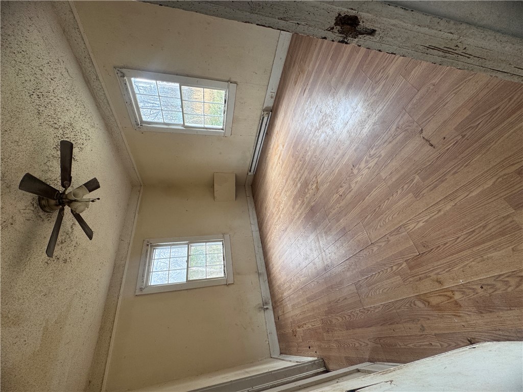 32 Ames Street Seneca, SC 29678 - Photo 9 of 14 This interior space features durable flooring and windows, offering a practical foundation for renovation.