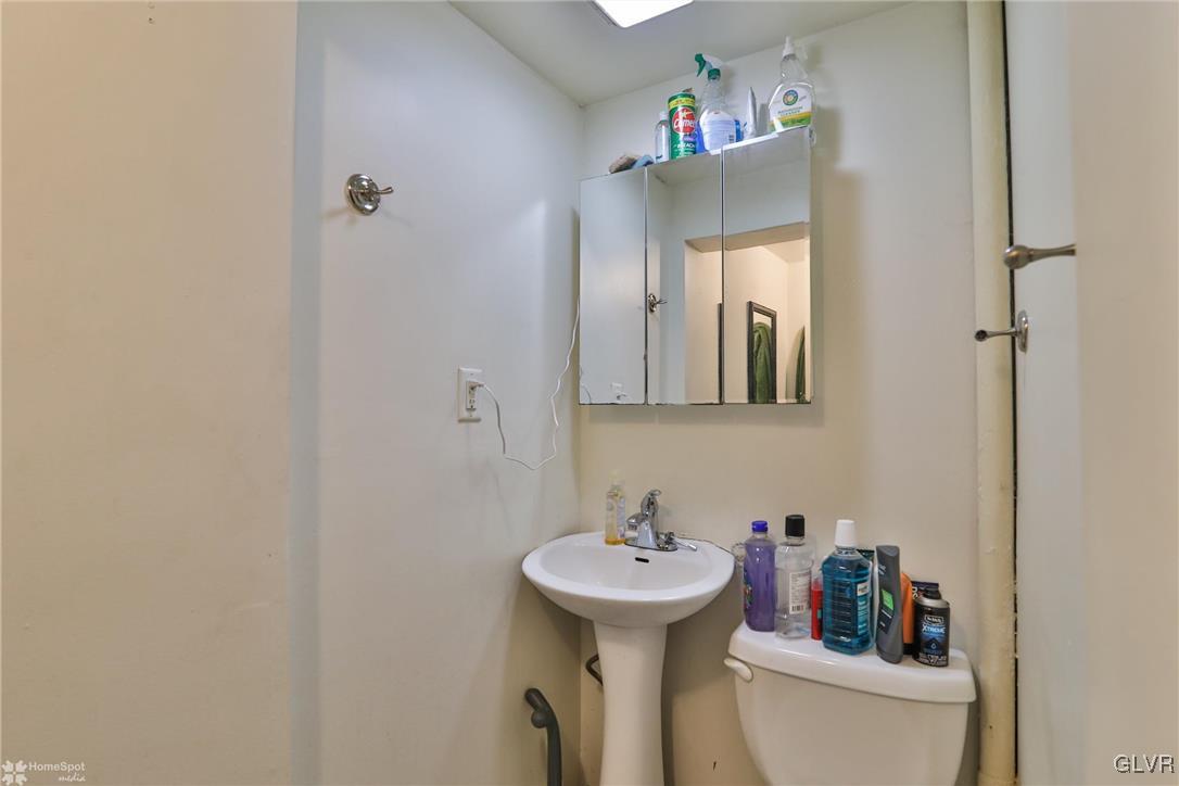 5562 Main Street Whitehall, PA 18052 - Photo 11 of 50 a bathroom with a sink toilet and a mirror