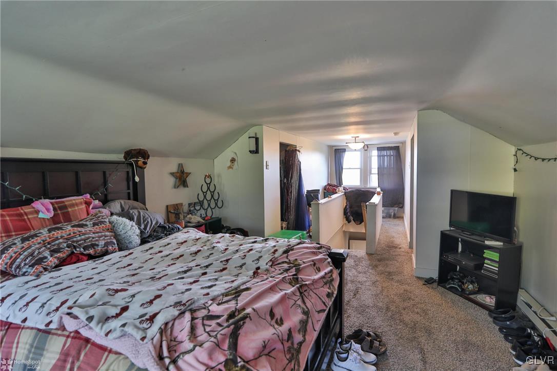 5562 Main Street Whitehall, PA 18052 - Photo 18 of 50 a bedroom with a large bed and a flat tv screen on a dresser