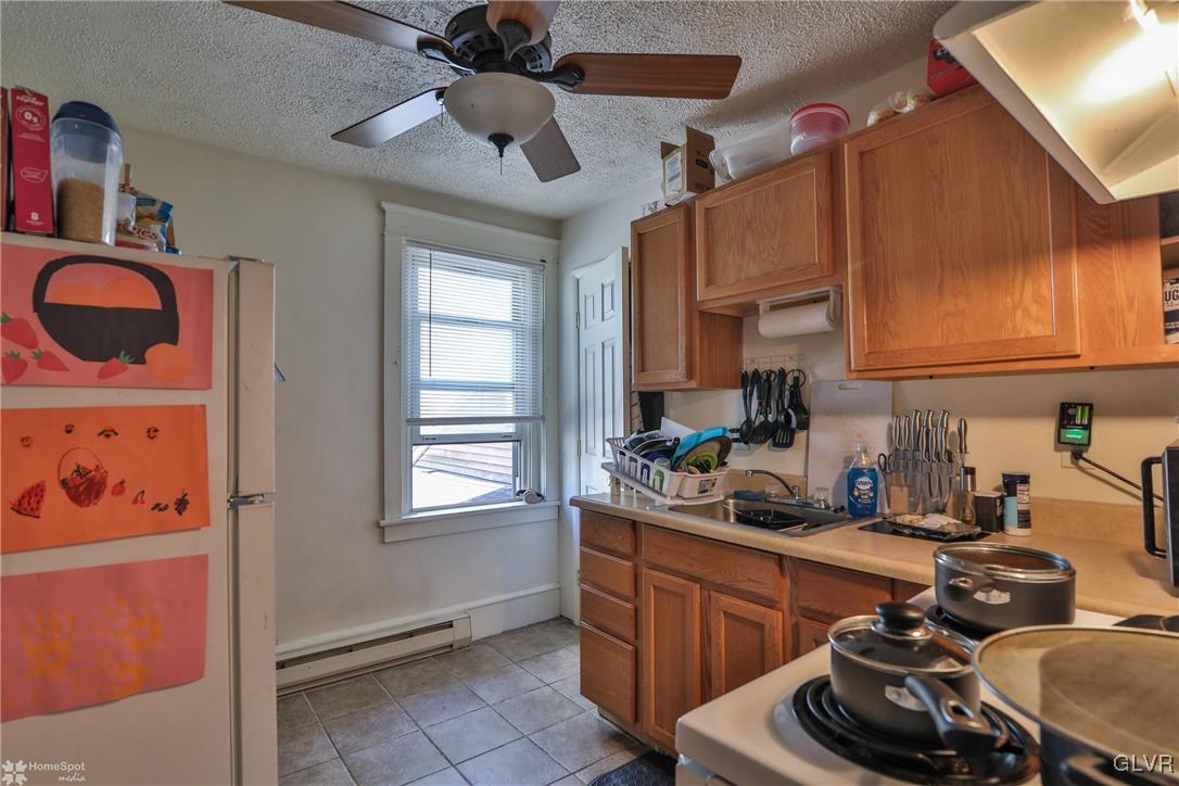 5562 Main Street Whitehall, PA 18052 - Photo 22 of 50 a kitchen with a sink stove and cabinets
