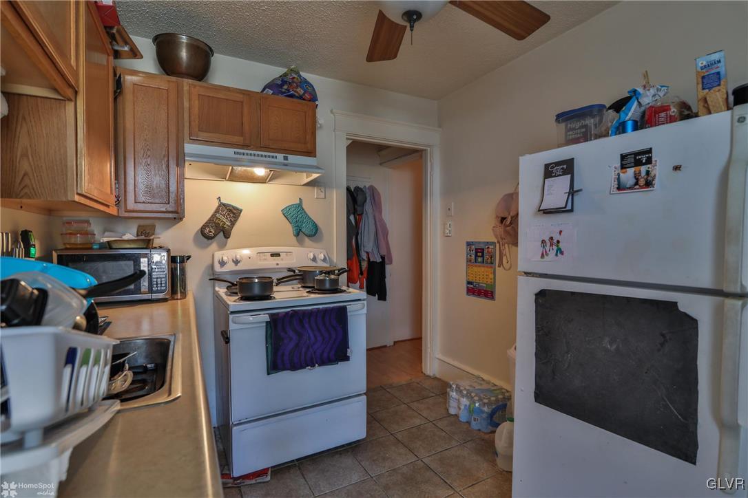 5562 Main Street Whitehall, PA 18052 - Photo 23 of 50 a kitchen with stainless steel appliances granite countertop a refrigerator and a stove