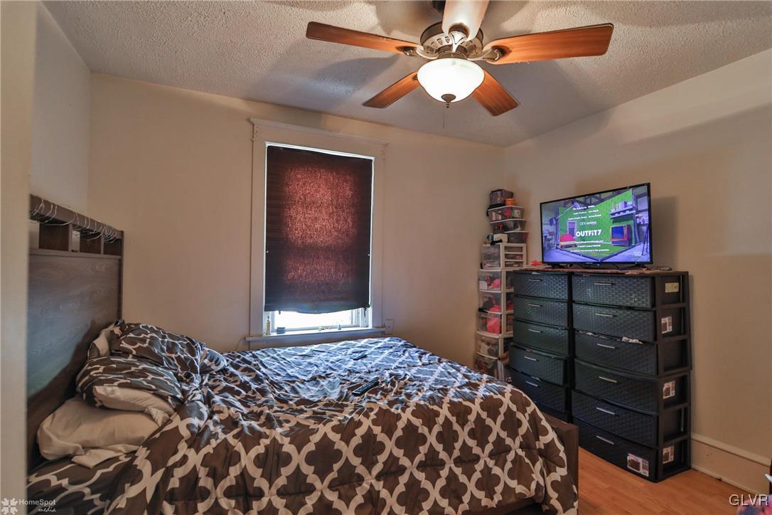 5562 Main Street Whitehall, PA 18052 - Photo 24 of 50 a bedroom with a bed and a flat screen tv