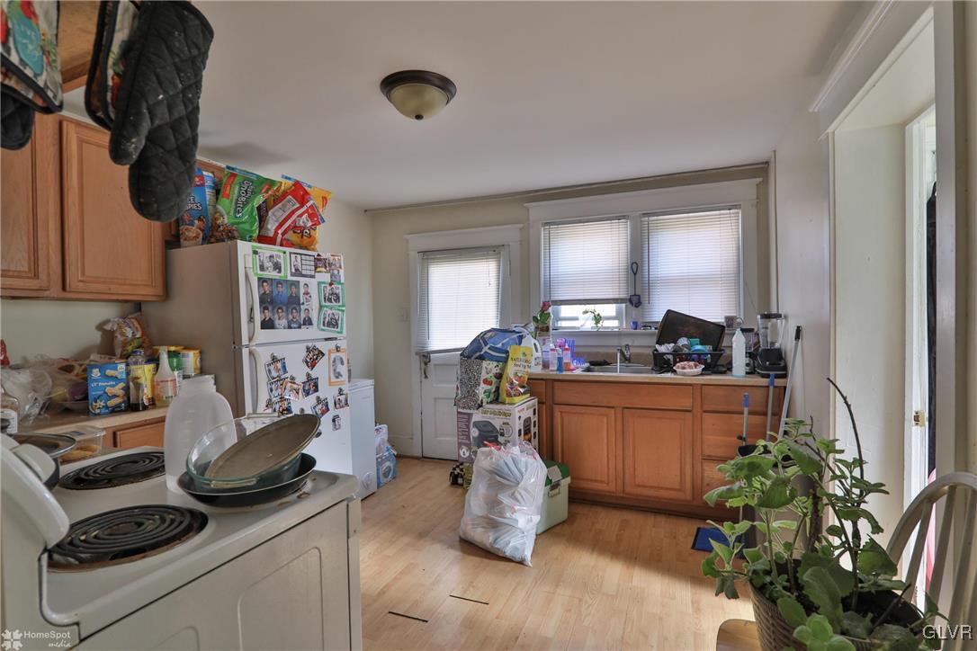 5562 Main Street Whitehall, PA 18052 - Photo 28 of 50 a kitchen with stainless steel appliances kitchen island granite countertop a sink stove and cabinets