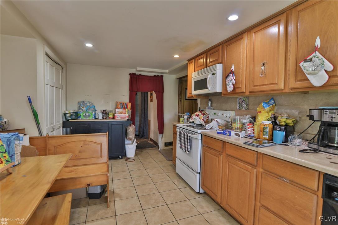 5562 Main Street Whitehall, PA 18052 - Photo 3 of 50 a kitchen with stainless steel appliances granite countertop a sink and a stove