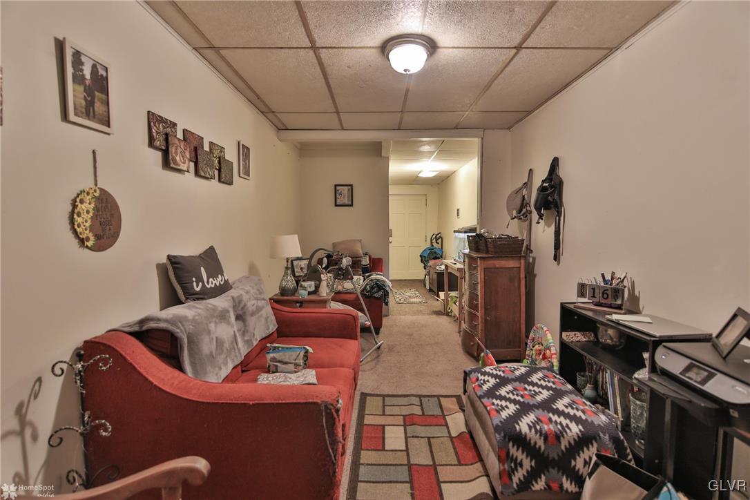 5562 Main Street Whitehall, PA 18052 - Photo 37 of 50 a living room with furniture a rug and a flat screen tv