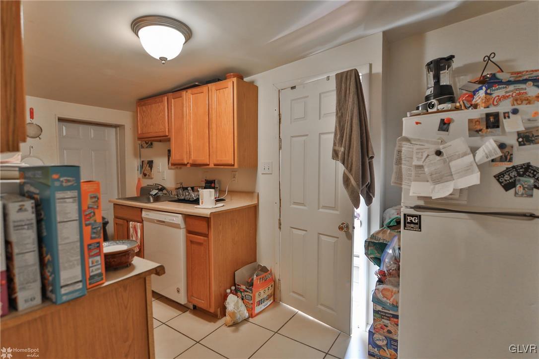 5562 Main Street Whitehall, PA 18052 - Photo 38 of 50 a kitchen with stainless steel appliances granite countertop a refrigerator and a stove top oven
