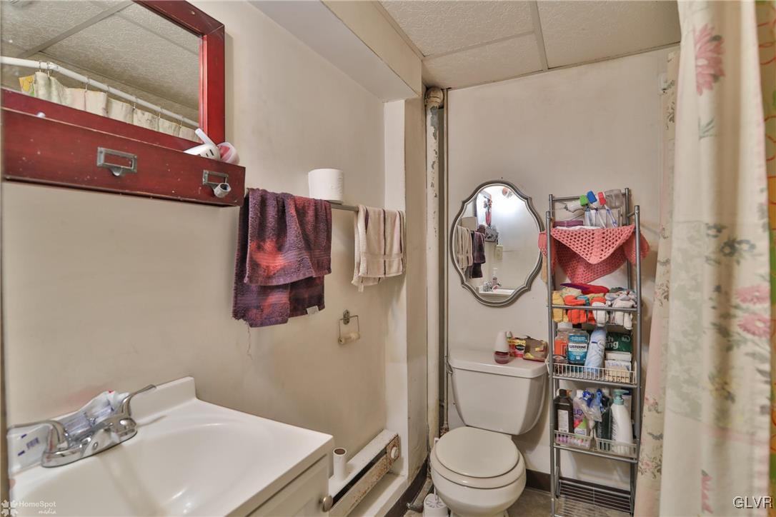 5562 Main Street Whitehall, PA 18052 - Photo 4 of 50 a bathroom with a toilet a sink and a mirror