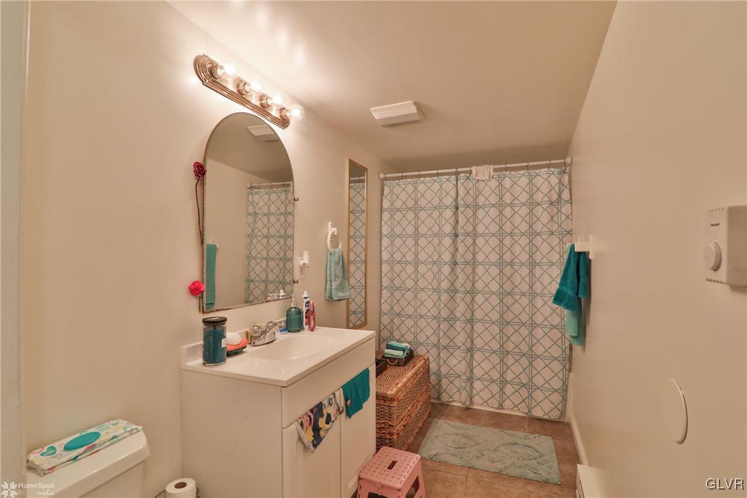 5562 Main Street Whitehall, PA 18052 - Photo 45 of 50 a bathroom with a sink vanity mirror and toilet