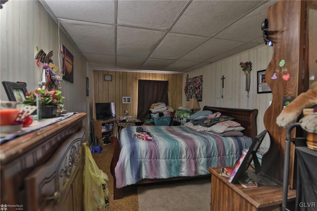 5562 Main Street Whitehall, PA 18052 - Photo 6 of 50 a bed room with a bed and a potted plant