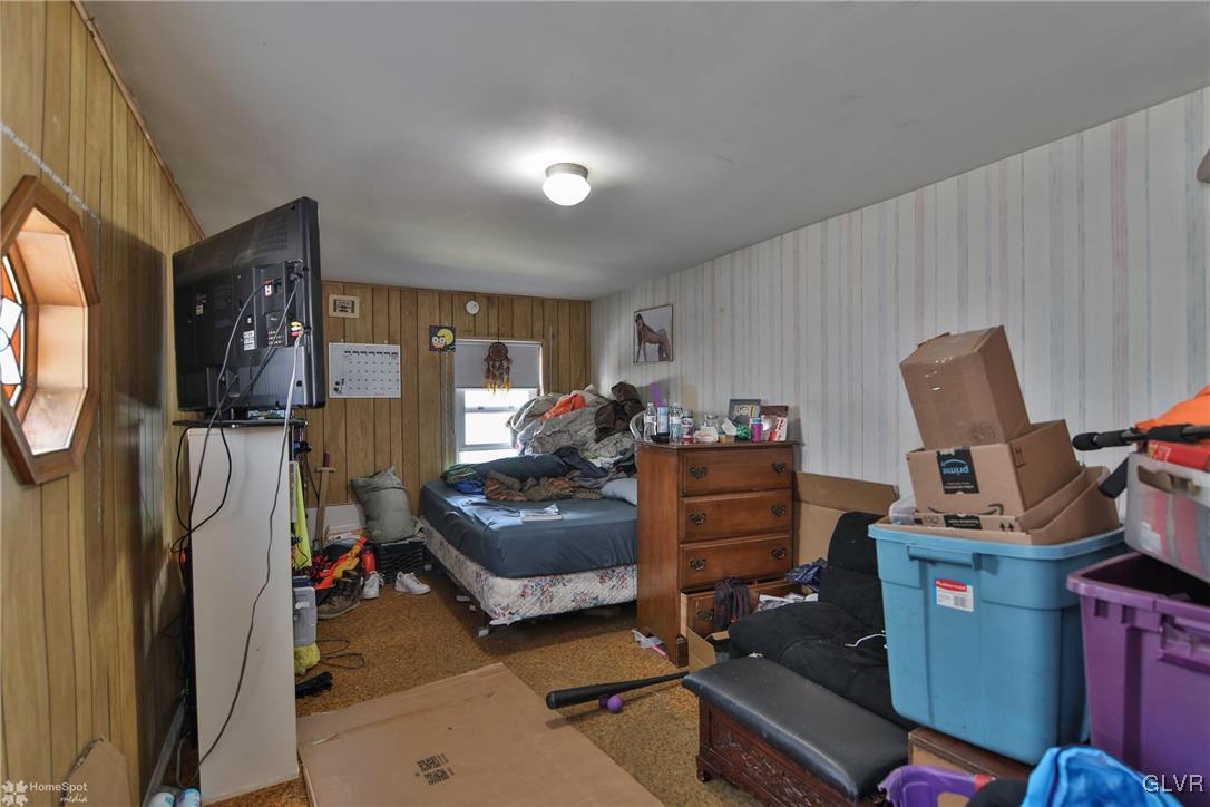 5562 Main Street Whitehall, PA 18052 - Photo 7 of 50 a living room with furniture a flat screen tv and a window