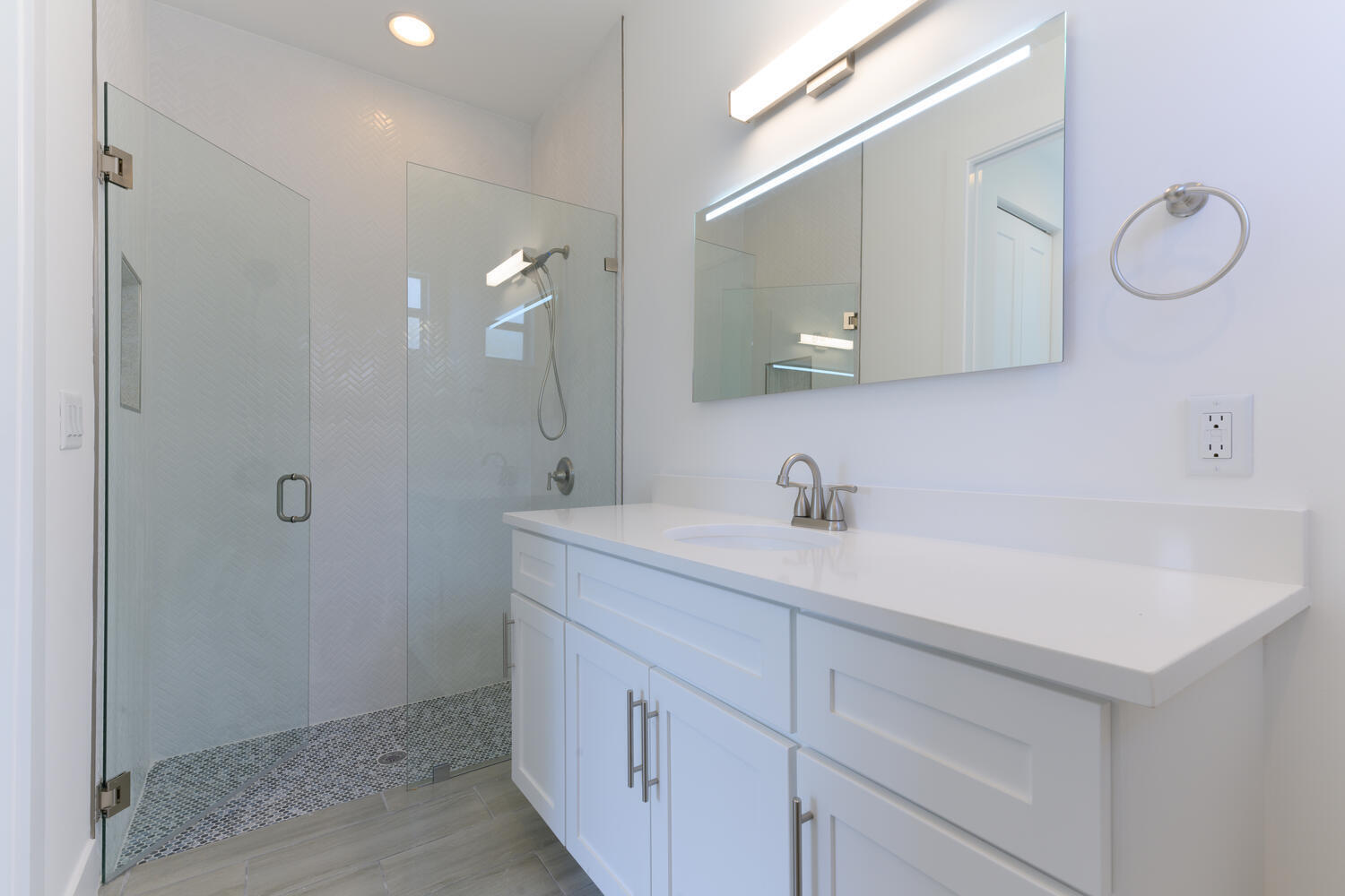 18058 Limestone Creek Road Jupiter, FL 33458 - Photo 13 of 30 a bathroom with a sink vanity and a mirror
