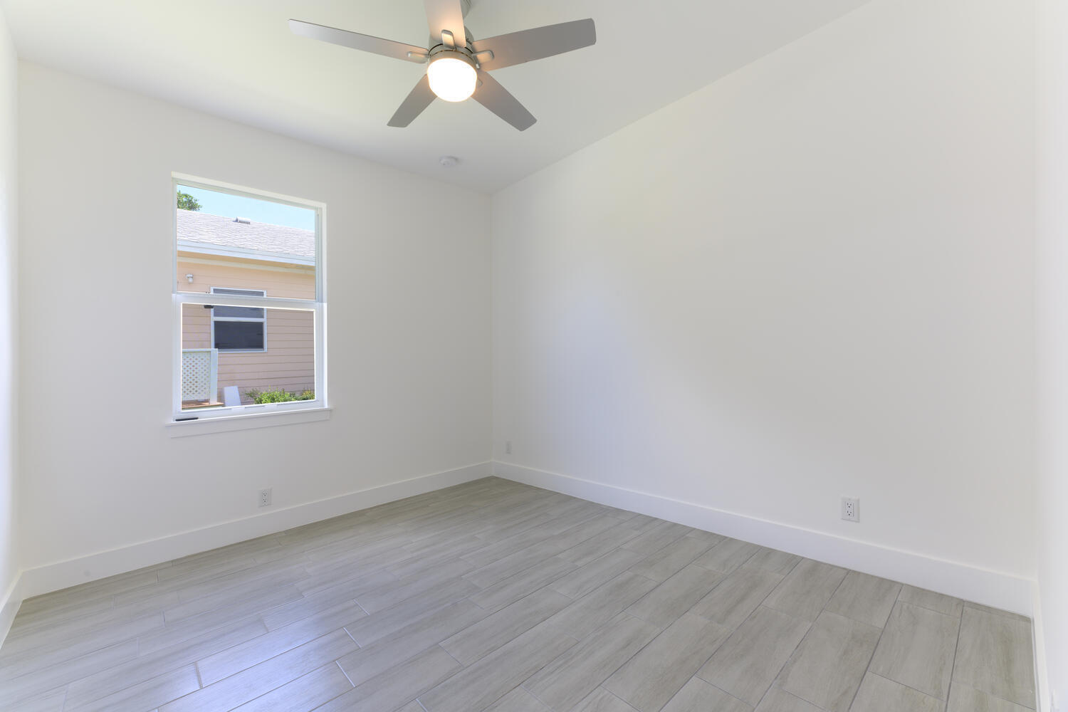 18058 Limestone Creek Road Jupiter, FL 33458 - Photo 22 of 30 wooden floor in an empty room with a window