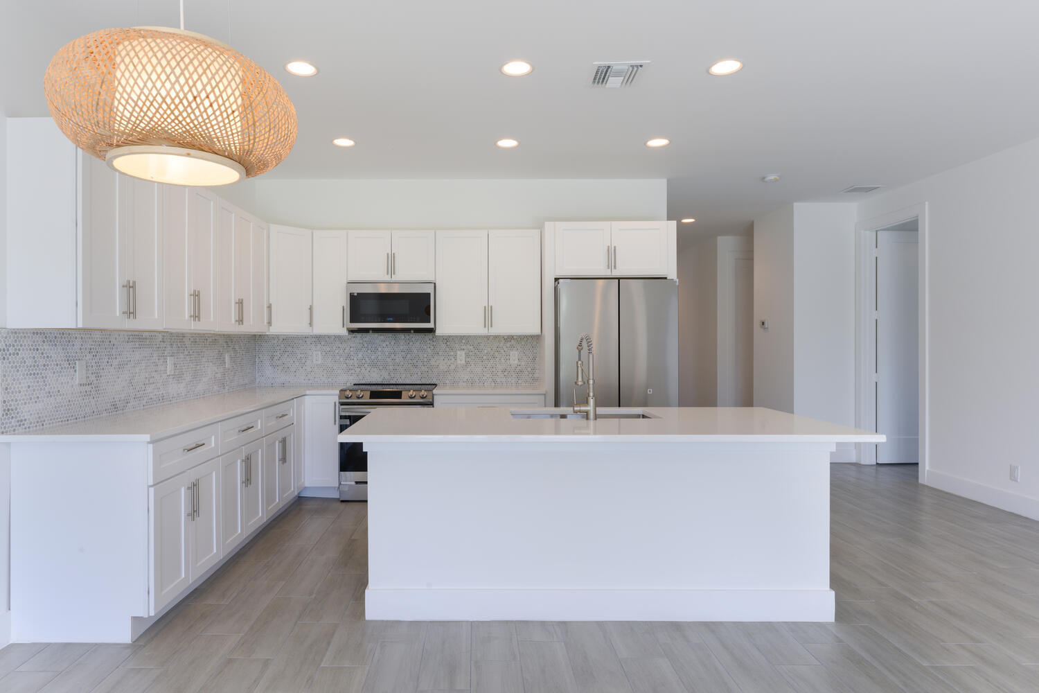 18058 Limestone Creek Road Jupiter, FL 33458 - Photo 8 of 30 a large kitchen with stainless steel appliances granite countertop a lot of cabinets and wooden floor