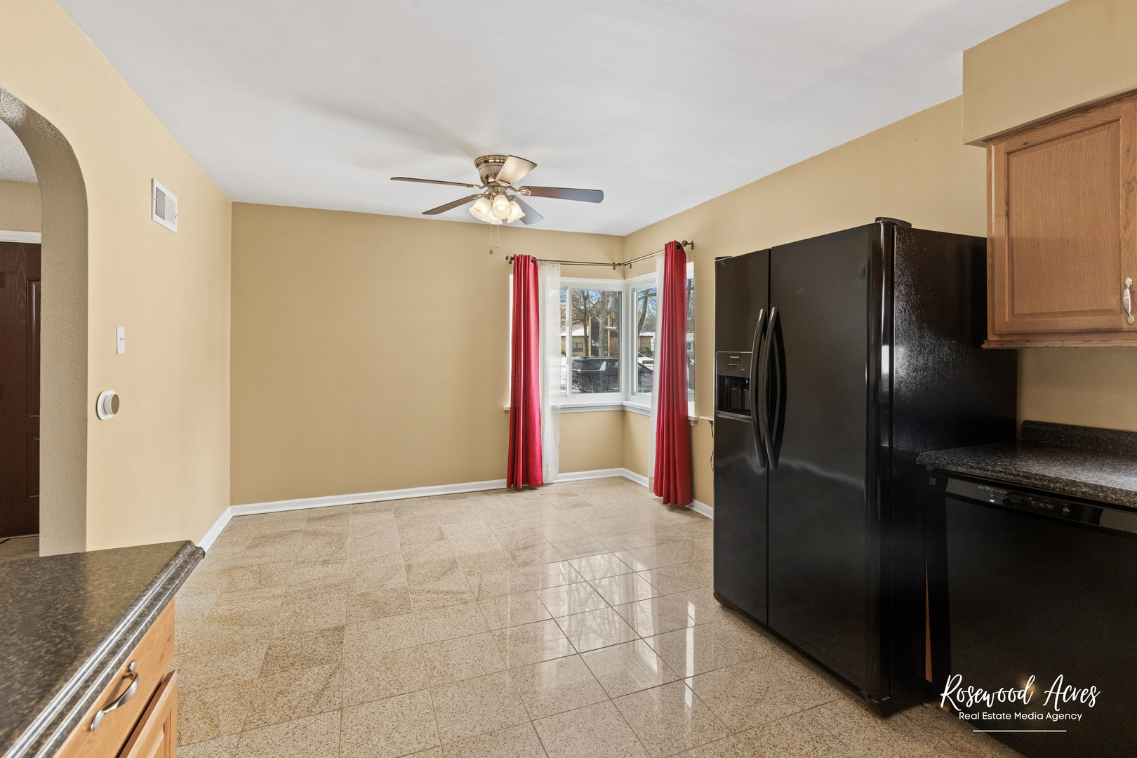 580 Enos Avenue Kankakee, IL 60901 - Photo 12 of 22 a view of a refrigerator in kitchen and an empty room
