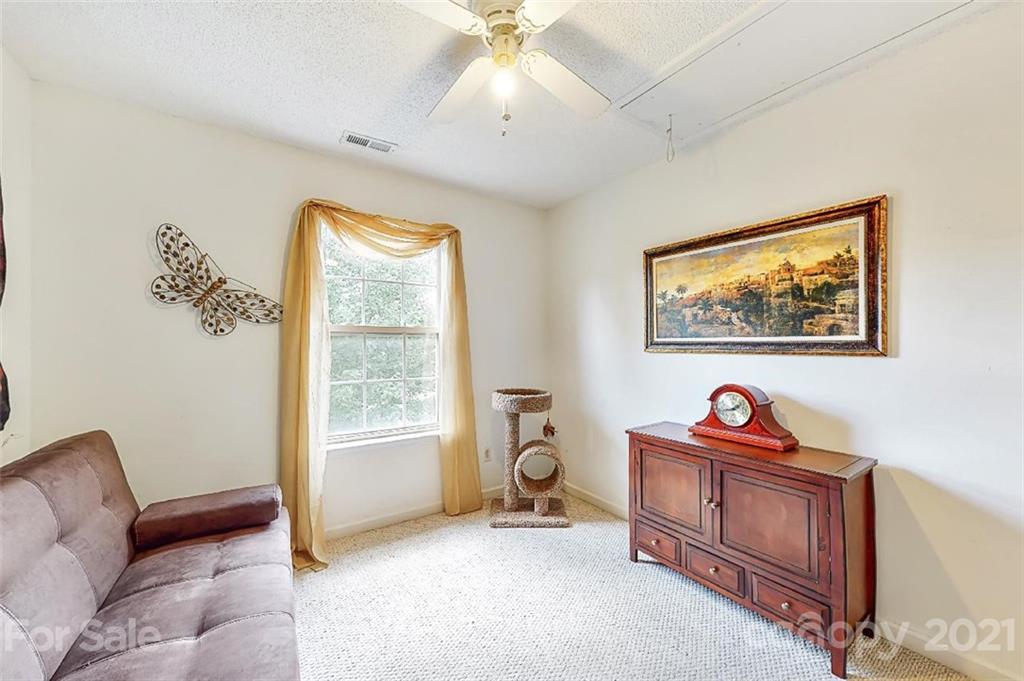 3053 Rockingham Court Southwest Concord, NC 28025 - Photo 22 of 28 a living room with furniture and a window