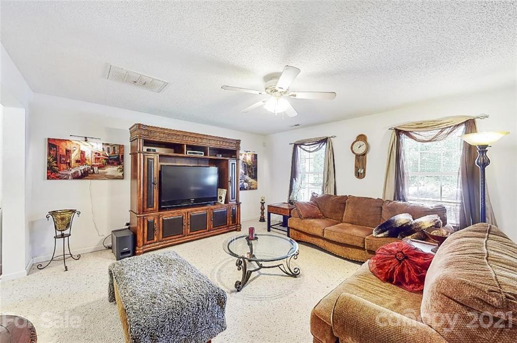 3053 Rockingham Court Southwest Concord, NC 28025 - Photo 4 of 28 a living room with furniture and a flat screen tv
