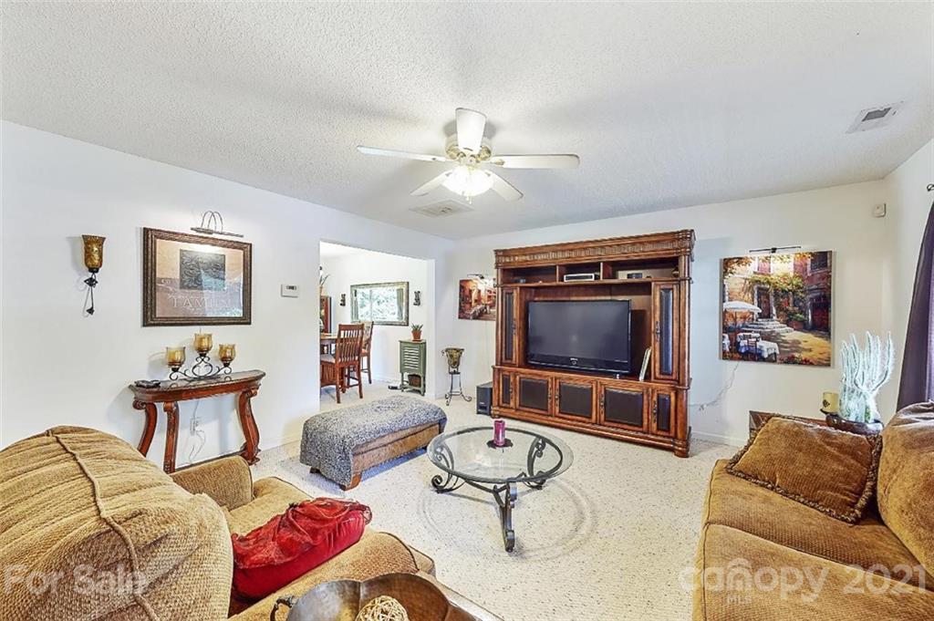 3053 Rockingham Court Southwest Concord, NC 28025 - Photo 5 of 28 a living room with furniture and a flat screen tv