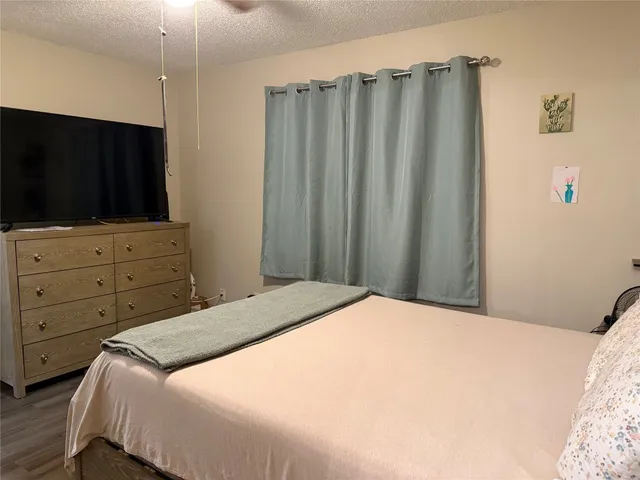 a bedroom with a bed and a television