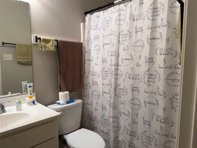 a white toilet sitting next to a bathroom sink