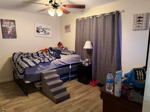 a bed room with a bed window and a chair