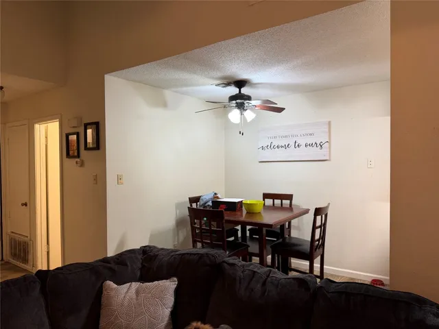 a view of a livingroom with furniture and dining area with chandelier