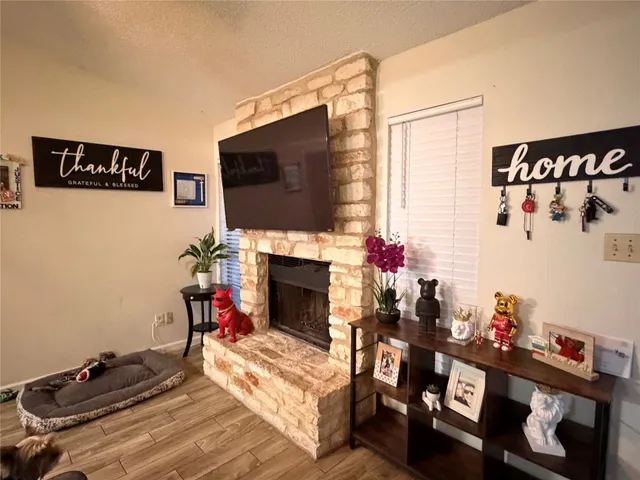 a living room with furniture a flat screen tv and a fireplace