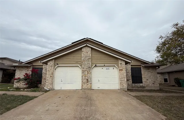 a front view of a house with a garage