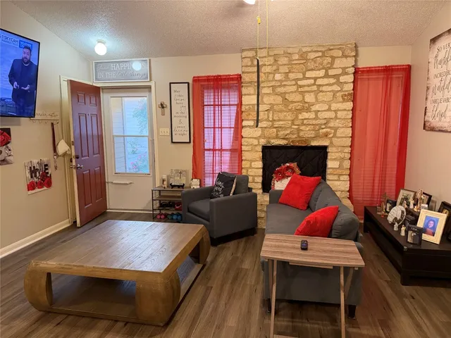 a living room with furniture fireplace and flat screen tv