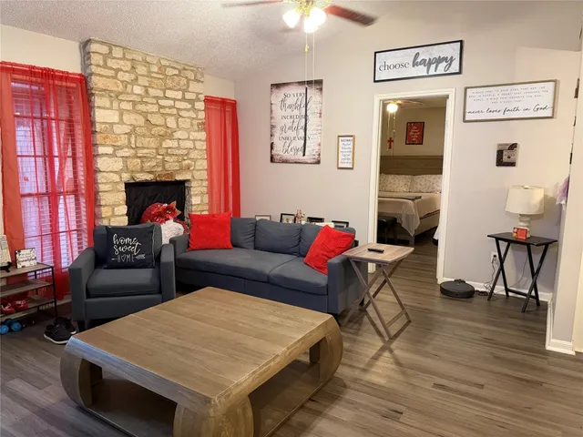 a living room with furniture and a fireplace