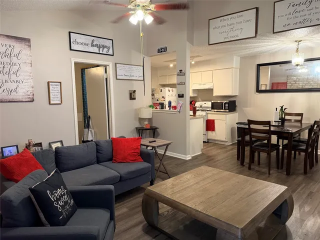 a living room with furniture and kitchen view