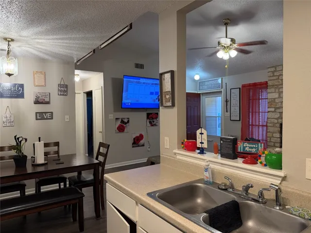a kitchen with a sink stove and refrigerator