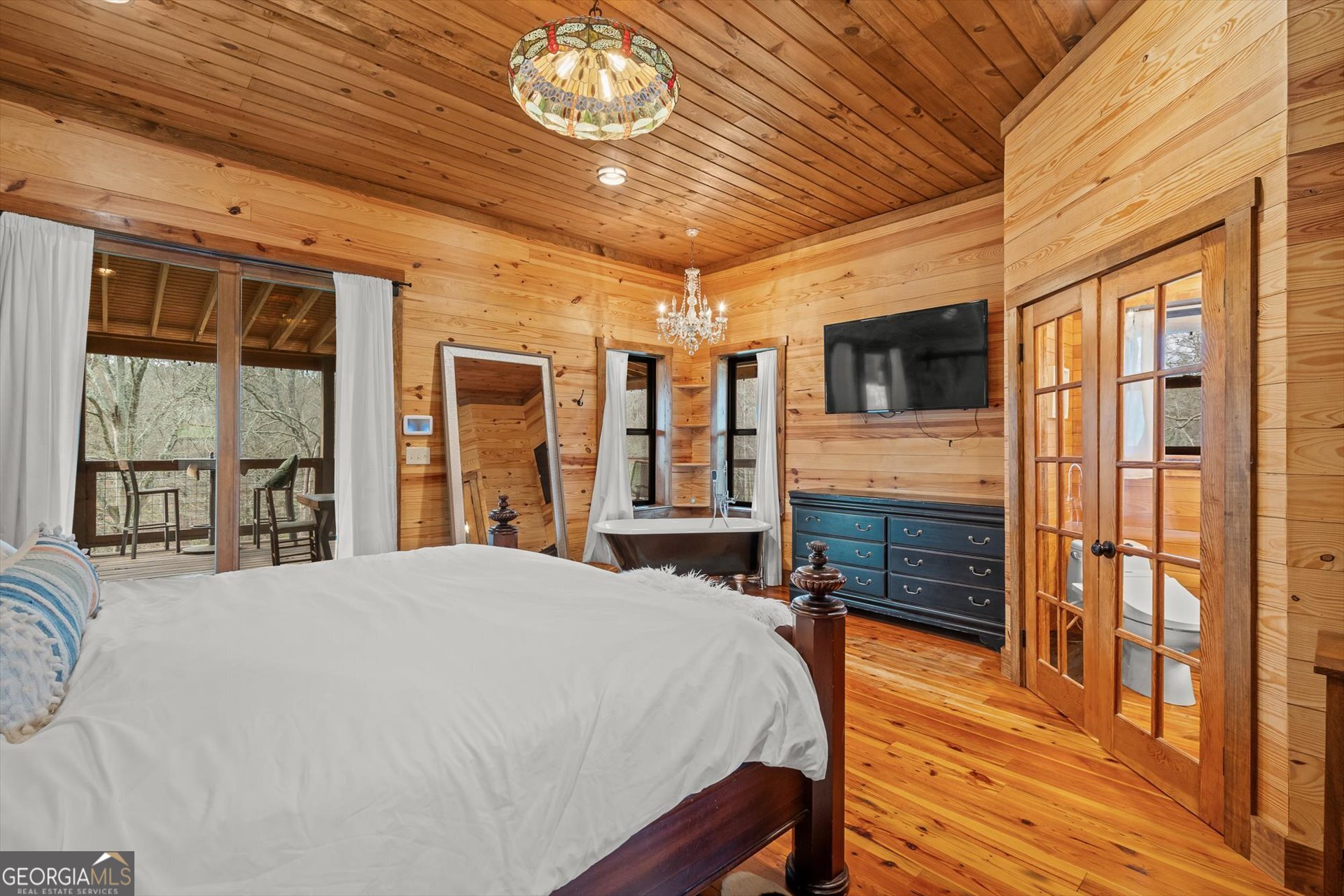 976 Salem Church Road Carrollton, GA 30117 - Photo 22 of 55 a spacious bedroom with a bed and wooden floor
