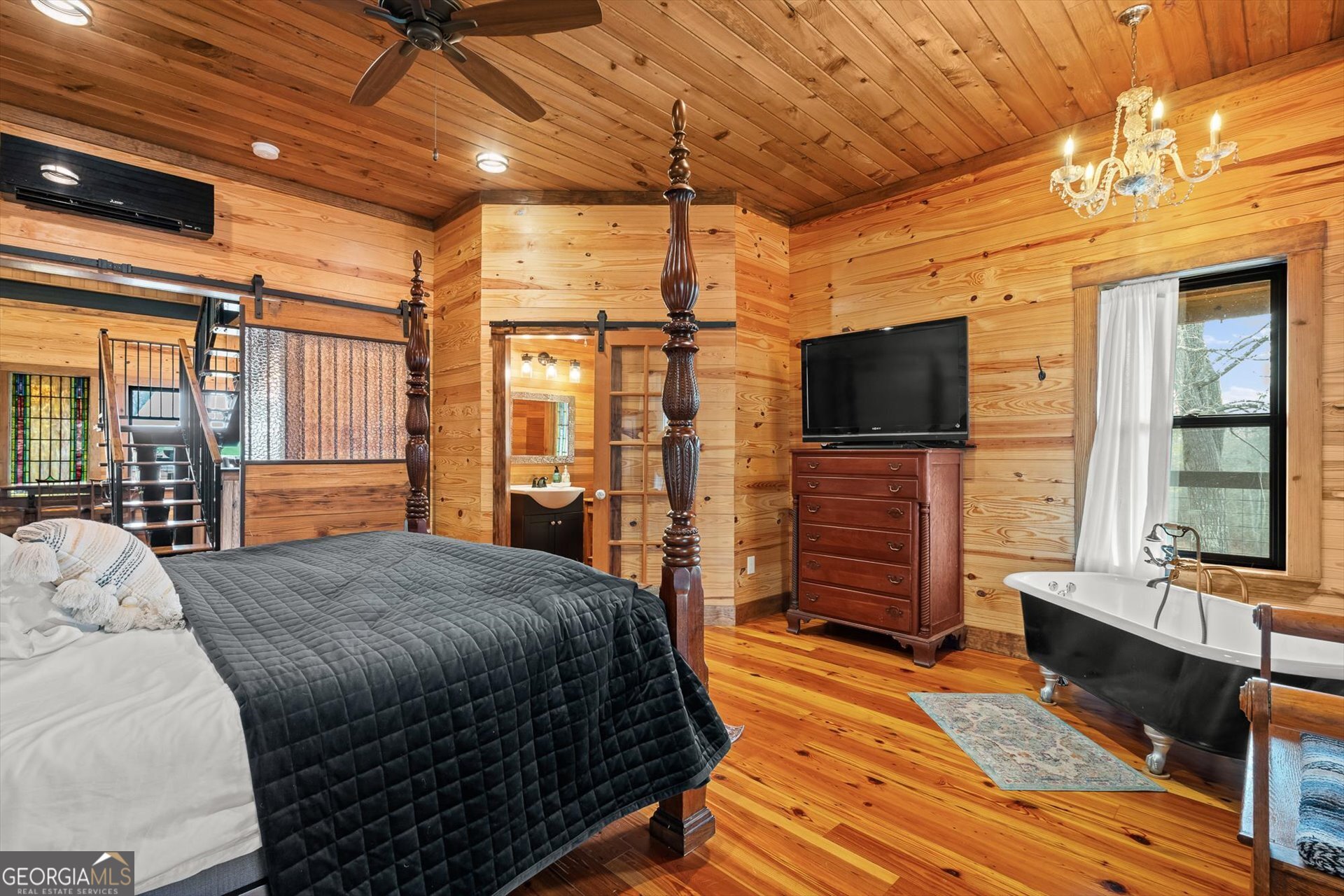 976 Salem Church Road Carrollton, GA 30117 - Photo 27 of 55 a bedroom with a bed and a flat screen tv